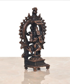 Copper Lord Krishna figurine with cow, angled view in decorative arched frame