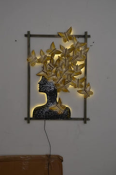 Gold butterfly-hair woman wall decor in rectangular frame with power cord