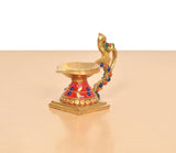 Brass peacock diya lamp, front view with red base, multicolor beads and golden bowl