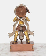 Back view of brass standing Hanuman murti with curved halo and textured drape