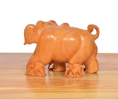 Wooden elephant showpiece, back view, carved rounded body and small front babies