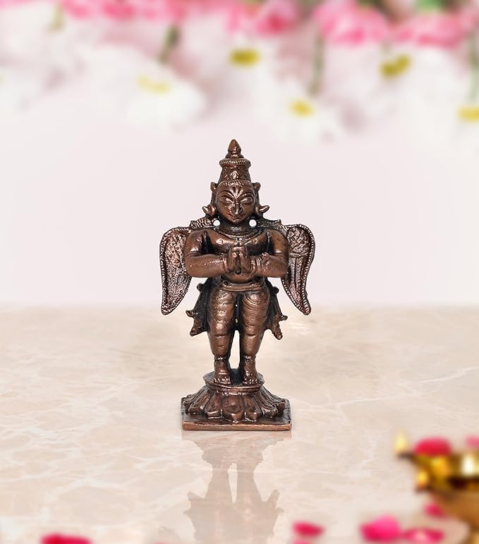Copper Garuda standing idol statue, arms crossed, detailed wings and crown