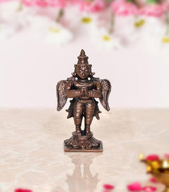 Copper Garuda standing idol statue, arms crossed, detailed wings and crown
