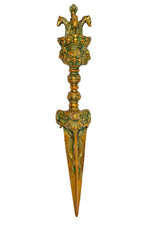 Vertical brass furba dagger pendant with deity head ornament and long pointed blade
