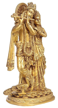 Brass Radha Krishna idol playing flute, standing pose with ornate crowns and robes