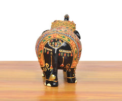 Wooden elephant showpiece rear view, black with orange-red detailing and floral painted borders
