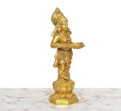 Golden brass Apsara lady holding an oil lamp, 3/4 angle figurine