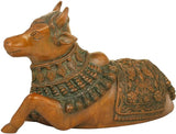 Brass Nandi figurine on side view, green-and-gold patterned saddle and collar