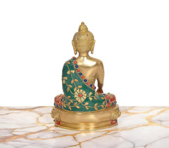Back view brass Buddha statue, green robe with colorful beads and red trim, seated