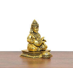 Gold Kuber idol brass statue, seated pose with beaded garlands and draped robe