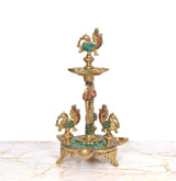 Brass peacock oil lamp stand with central stem and side diya holders