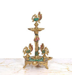 Brass peacock oil lamp stand with central stem and side diya holders