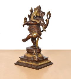 Brass Lord Ganesha dancing murti in standing pose, gold-toned accents, broad base