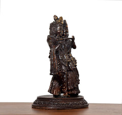 Brass Radha Krishna idol, side profile view with flowing robes and ornate headdress.
