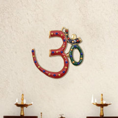 Brass OM wall hanging with red base, blue beads, gold trim, and green inner 0