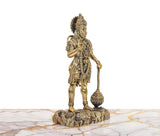 Brass Hanuman Ji figurine holding tail-like mace, detailed armor on rocky base