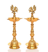 Brass peacock oil lamp stand set of 2, straight-on view with flared diya bowls