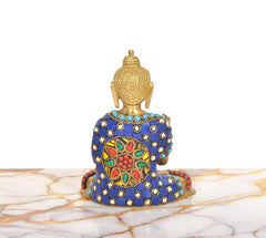 Back view of brass Buddha idol with blue gem robe and decorative red gold medallion