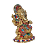 Brass Ganesha idol statue, front-left view, raised hands and red bead detailing