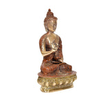 Brass Buddha idol three-quarter view, hands in blessing pose, engraved pedestal
