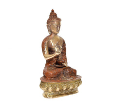 Brass Buddha idol three-quarter view, hands in blessing pose, engraved pedestal