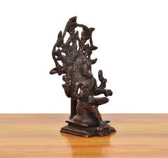 Brass Dakshinamurti Shiva murti angled view, sculpted hands and crown details