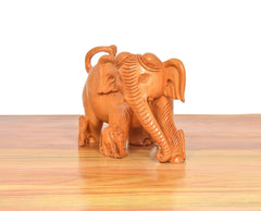 Wooden elephant showpiece, front-left angle, detailed ridged body and ears