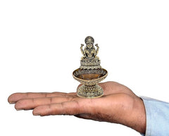 Brass Lakshmi diya oil lamp figurine held in hand, ornate base and tray