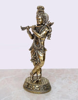 Brass Lord Krishna playing flute figurine, detailed ornaments, round pedestal base