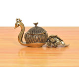 Brass duck kumkum box showpiece with black-and-gold patterned domed lid and side peacock