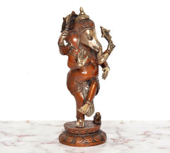 Dancing Ganesha brass figurine, angled view with headdress and upraised trunk