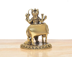 Brass Dattatreya murti rear/side view on elephant, ornate base with etched pattern