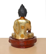 Back view Buddha statue: dark textured head, gold back robe panels, seated on carved round base