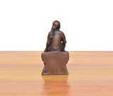 Rear view of dark copper Shirdi Sai Baba statue, flat base