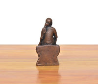 Rear view of dark copper Shirdi Sai Baba statue, flat base