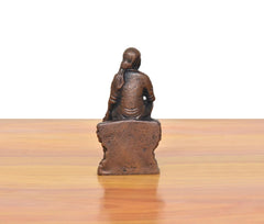 Rear view of dark copper Shirdi Sai Baba statue, flat base