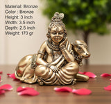 Brass Lord Bal Gopal and cow idol figurine, seated pose, ornate details