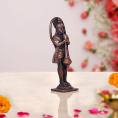 Copper Hanuman statue side view, arched halo and draped robe, small base
