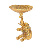 Golden metal elephant-shaped dry fruit bowl, side view on pedestal