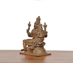 Copper Lakshmi Narasimhar idol, side view showing crown, jewelry, and base details