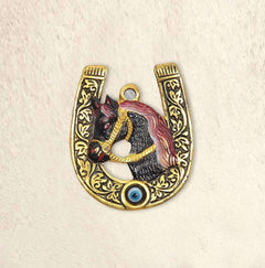 Metal horseshoe wall hanging with horse head and blue evil-eye bead in gold