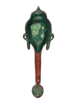 Backside of Buddha-face door handle, green patina head and red stem