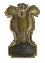 Brass lion wall hanging back view with textured design and pedestal base