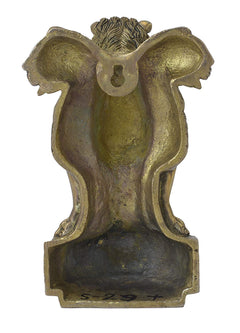 Brass lion wall hanging back view with textured design and pedestal base