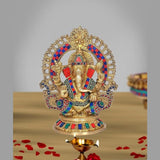 Brass Ganesha idol with multicolor enamel, ornate halo, seated pose on round base