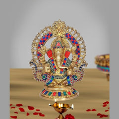 Brass Ganesha idol with multicolor enamel, ornate halo, seated pose on round base