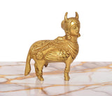 Brass Kamdhenu cow figurine, golden finish, front-left profile