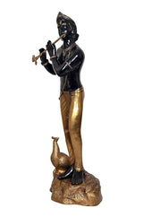 Krishna flute figurine side view, black torso, gold dhoti, peacock figure on base