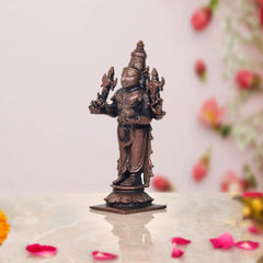 Copper Dhanvantari statue three-quarter angle, four-armed form with adornments