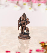 Copper Kal Bhairav idol, side view, holding trident and staff on lotus base